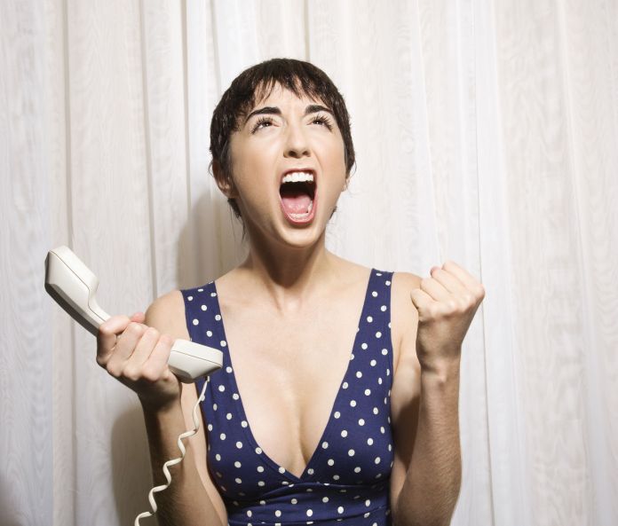 Woman with phone screaming.